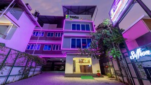 A multi-story building with a 'treebo' sign, indicating a business or service on the ground floor. - Treebo Vsaffron Regency, Punnamada Lake (Ambalapuzha)