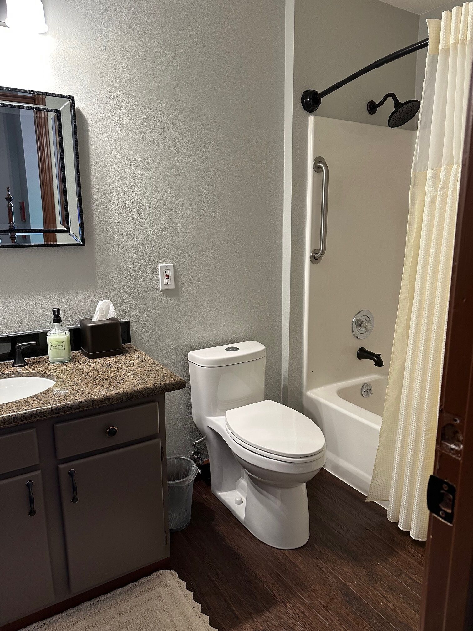 A bathroom with a toilet, sink, and bathtub.