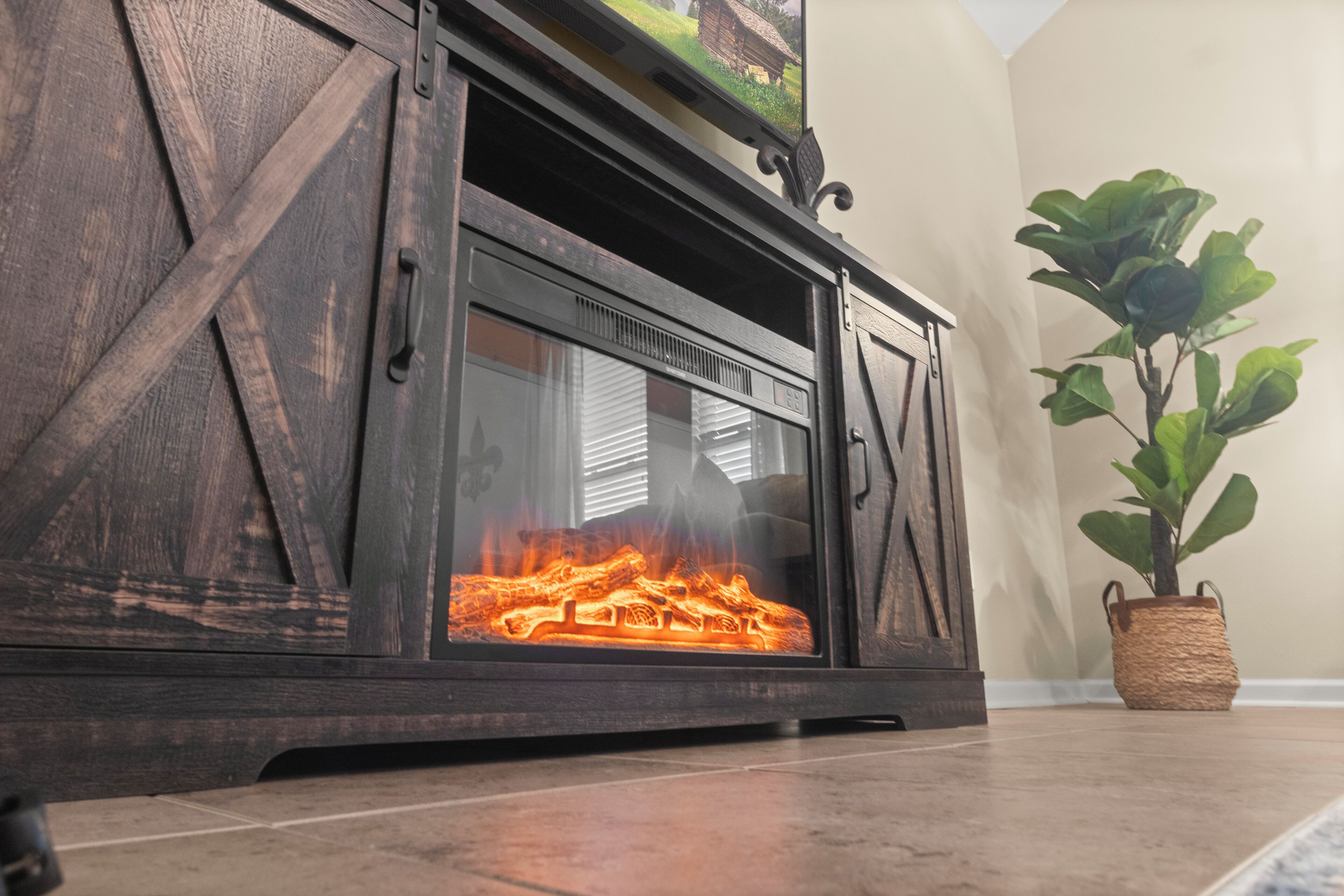 A fireplace with a rustic design, a potted plant beside it, and a window with blinds.