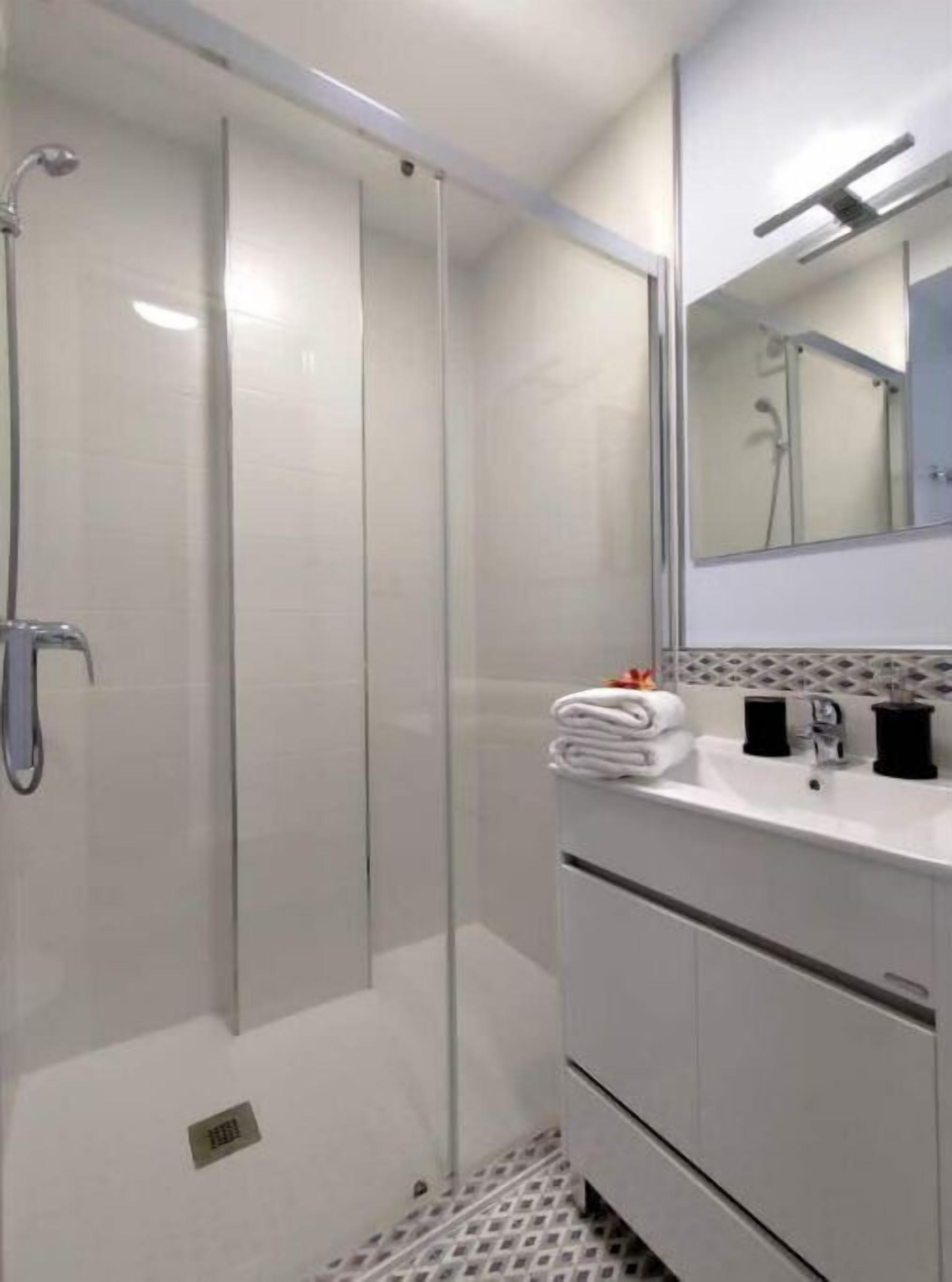 Shower, hair dryer, towels, toilet paper