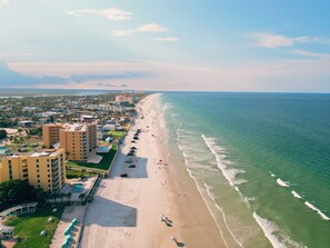 A coastal hotel with multiple floors, a beachside location, and a view of the ocean. - LaLa`s Beach House, Two!  - Walking Distance to the Beach and Great Shopping!  (New Smyrna Beach)