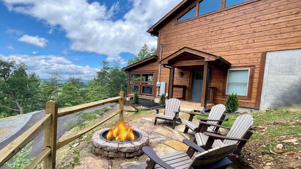 A wooden cabin with a fire pit and outdoor seating. - Bearly Behaving (Sevierville)