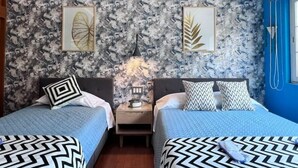 A bedroom with two beds, a nightstand, and a wall with abstract art. - Designful Apartment in Trendy Roma Norte/Condesa (Ciudad de México)