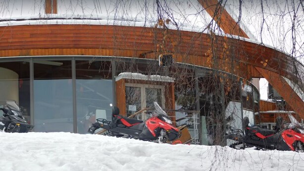 Un edificio con fachada de madera y entrada de vidrio.