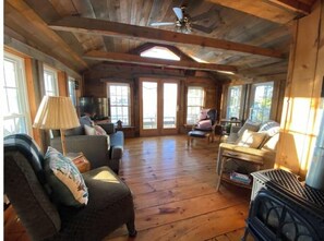 Relax in a warm and inviting space with a sofa, armchairs, and bench, perfect for unwinding by the fireplace.