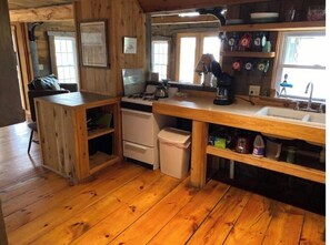 Kitchen features a gas stove, sink, and coffee maker, with ample storage and a central island.