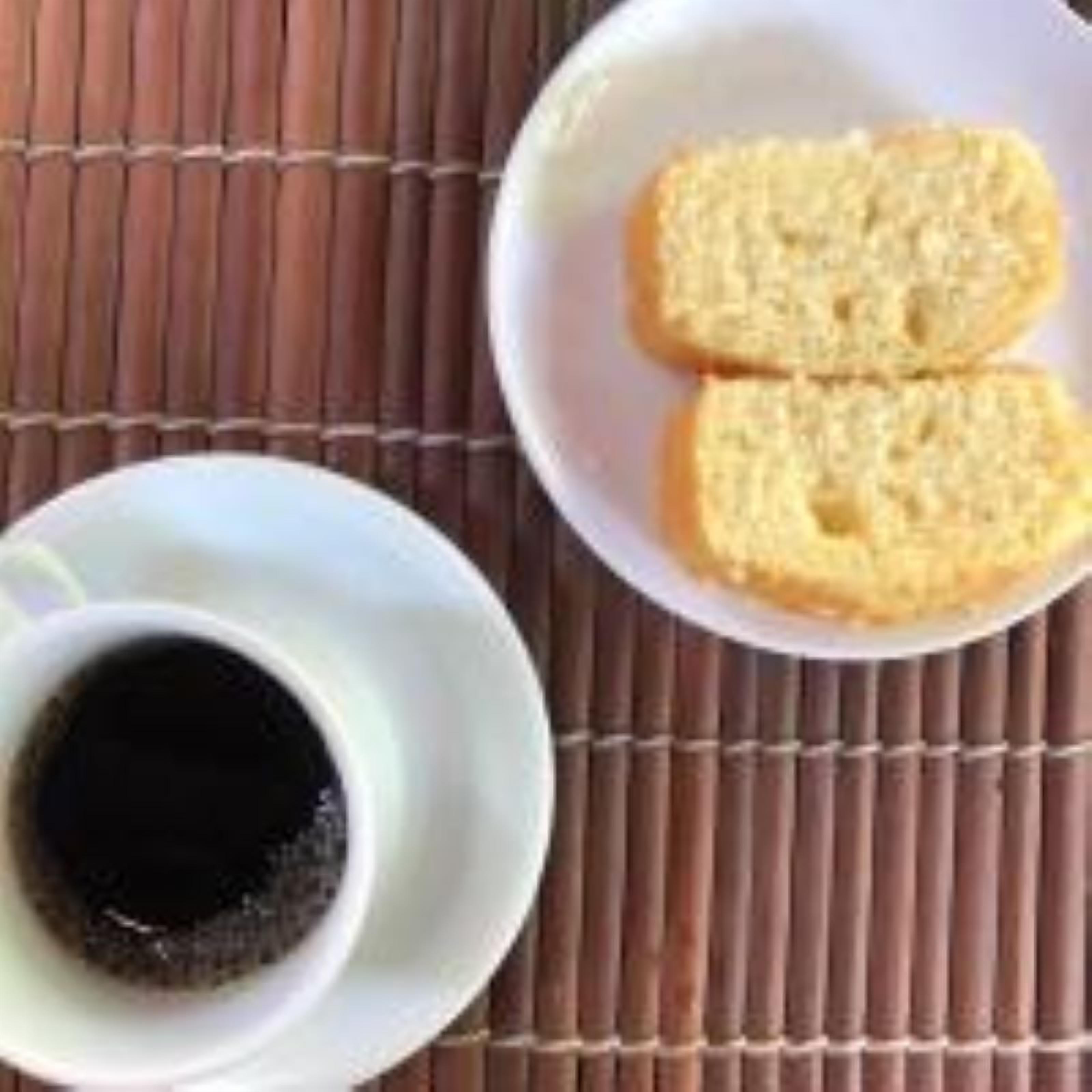 Una taza de café blanco sobre una estera de bambú.