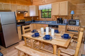 Effortlessly prepare meals in this well-equipped kitchen with a central island, stainless steel appliances, and ample natural light.