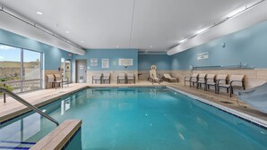 A swimming pool with lounge chairs and a lifeguard station. - Holiday Inn Express & Suites Marinette by IHG (Marinette)