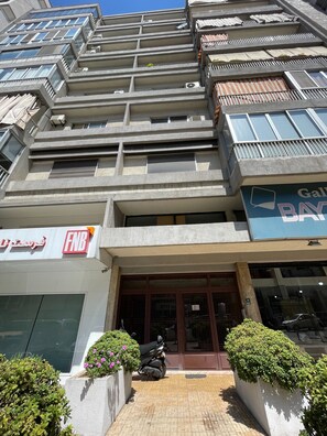A multi-story building with a ground-level entrance, a visible FNB bank sign, and a visible Bay window.