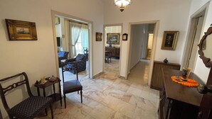 A spacious living area with a marble floor, a dining table with chairs, a sofa, and a chandelier. - New Jdeideh, Including Generator, Furnished Apartment, Parking, Great Location (Jdeideh)