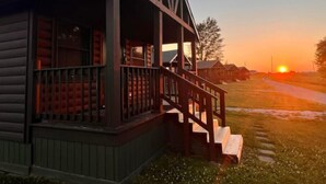 A log cabin with a porch and steps leading to a deck. - Cabin close to Lake Rathbun #1
 (Melrose)