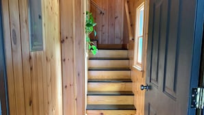 A wooden interior with a staircase leading to a door. - Down the road from Bayview Beach on Ferry Rd! Bright, and newly furnished 2 BR. (Saco)