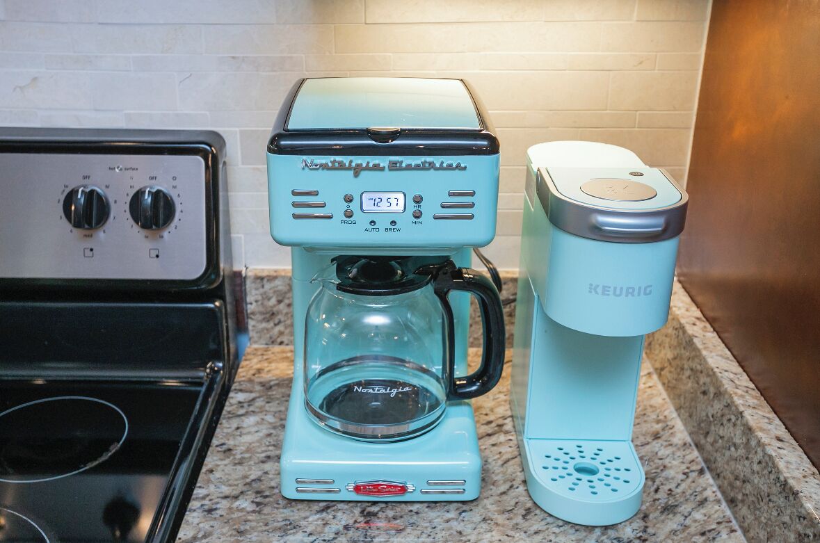 A kitchen with a coffee maker and a Keurig coffee pod dispenser.