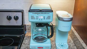 A kitchen with a coffee maker and a Keurig coffee pod dispenser.