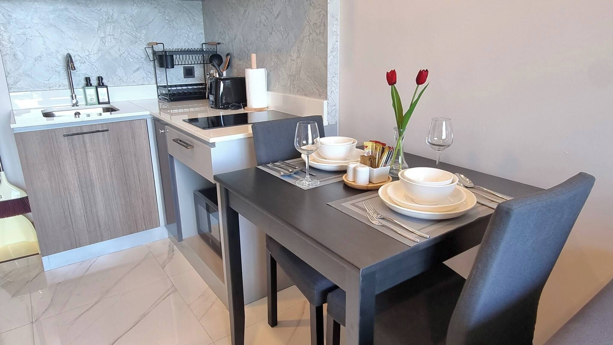 A modern kitchen with a dining area.