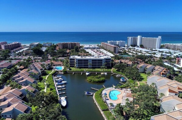 A coastal hotel with a marina, a swimming pool, and a view of the ocean.