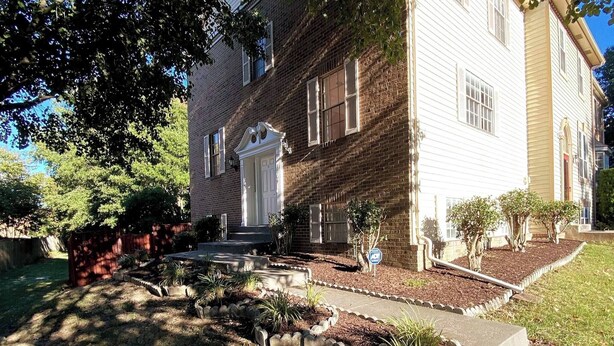 A two-story building with a brick facade and a white front door. - Room in House - The Modern Gem Furnished Bedroom (Alexandria)