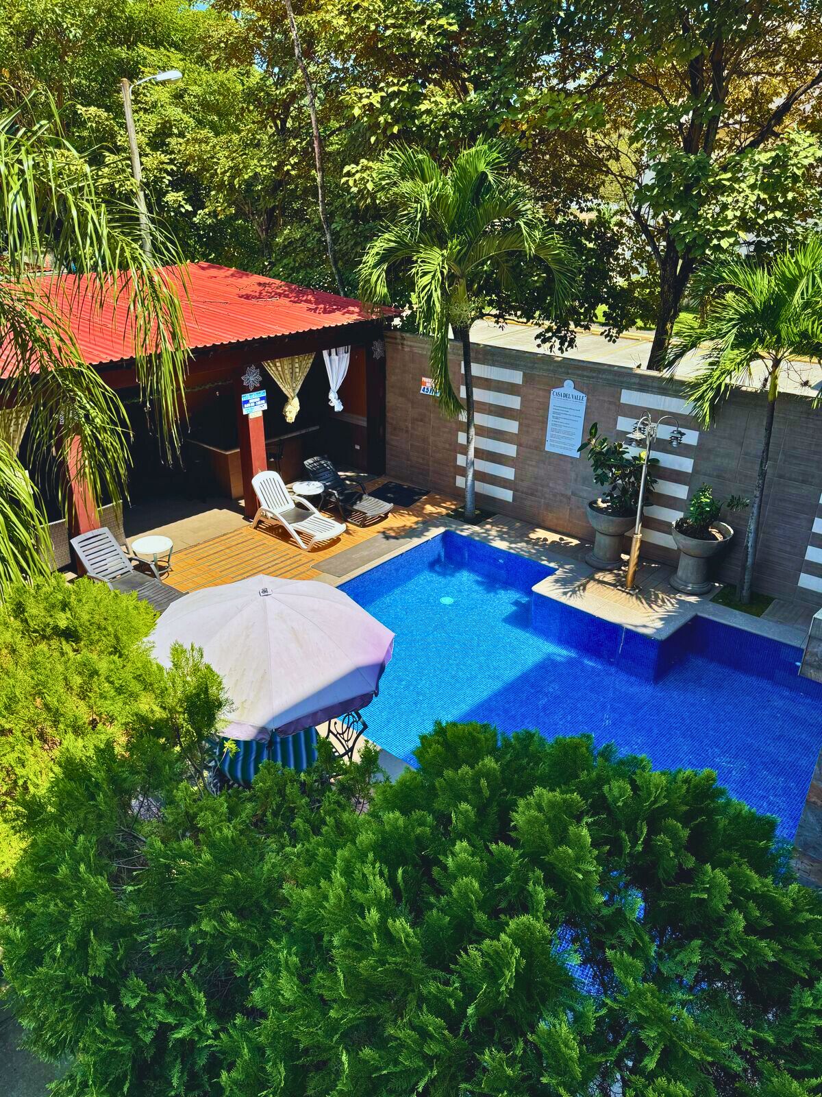 2 outdoor pools, open 8:00 AM to 7:00 PM, pool umbrellas