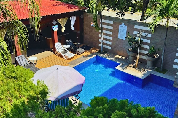 2 outdoor pools, open 8:00 AM to 7:00 PM, pool umbrellas