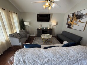 A modern living room with a sofa, armchair, and a coffee table.