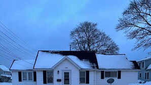 A single-story house with a snow-covered roof and a number 109 sign on the front door. - Cozy house ON the ATV/ORV trail located in Newberry.  Great for year round fun.  (Newberry)