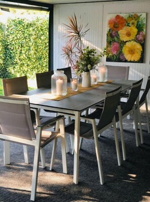 Enjoy meals with family and friends in this cozy dining area, featuring a large table and comfortable seating for six.