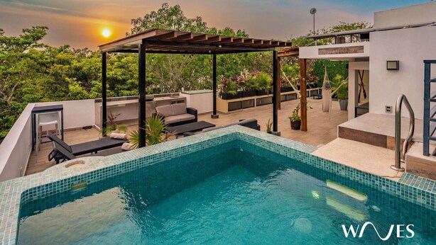 A rooftop pool with a pergola, lounge chairs, and a view of the sunset. - 3br - Exclusive Townthouse - Private Rooftop Pool (Tulum)
