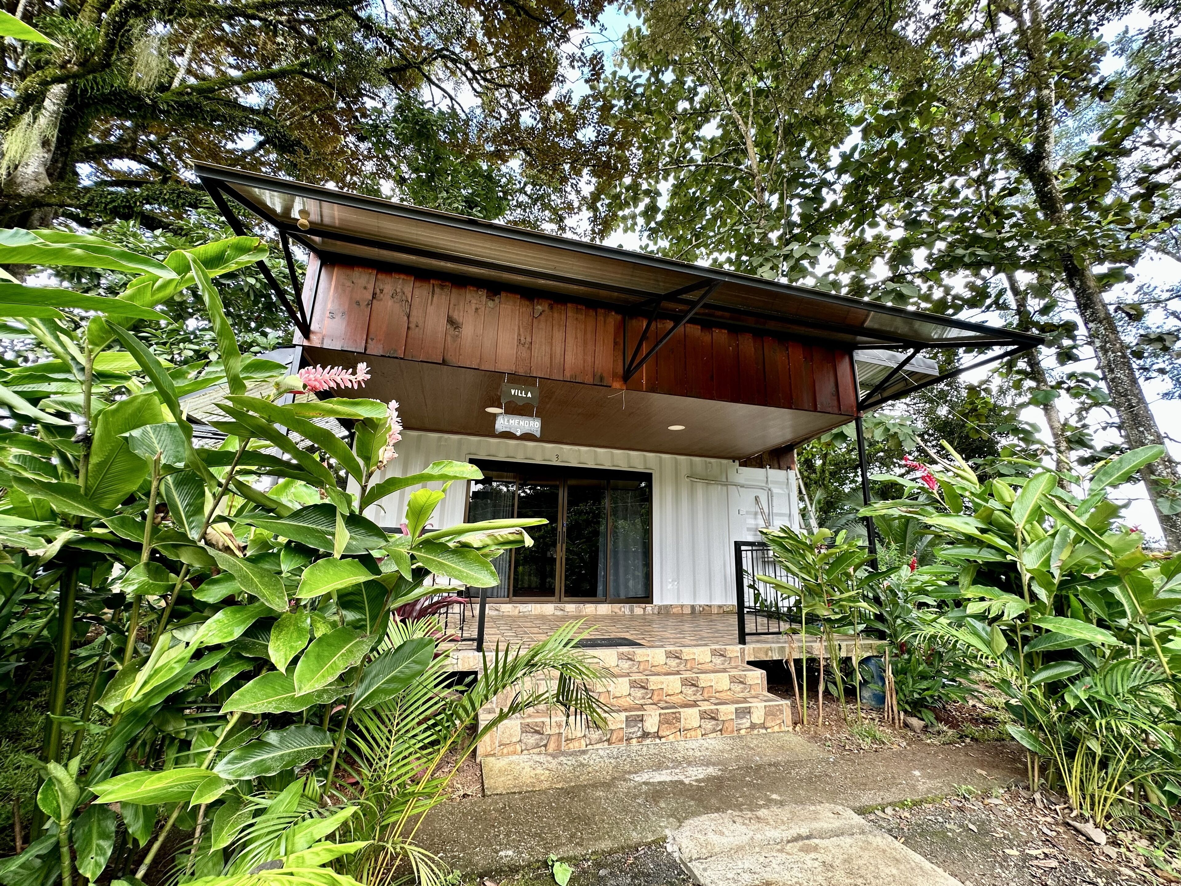 A villa with a wooden roof and a sign indicating it is Villa Alhendro 3.