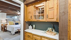 A wooden kitchen with a countertop, cabinets, and a sink. - Walk to Downtown Banner Elk | Hot Tub, Movie Room & Game Room | Sleeps 17 (Banner Elk)