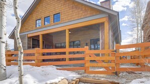 A wooden cabin with a porch, stone steps, and a wooden fence. - Mountain Views: Luxurious Grand Lake Escape! (Grand Lake)