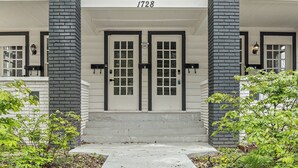 A two-story building with a white facade and black brick accents. - ⭐Modern 2 Bedroom Unit ⭐ Convenient ⭐ Near Downtown, Convention & Hospitals ⭐ (Indianapolis)