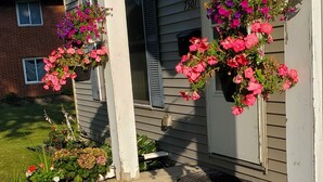 A house with a porch decorated with various potted plants and flowers. - Beautiful 3br, 1.5 bath townhouse centrally located in the heart of Milwaukee. (Milwaukee)