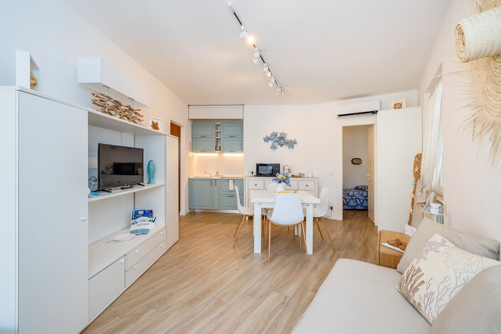A modern apartment with a dining area, kitchen, and living room.