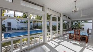 A covered outdoor area with a pool, dining table, and chairs. - Walk to the beach & restaurants @ Las Terrenas for 10! (Las Terrenas)