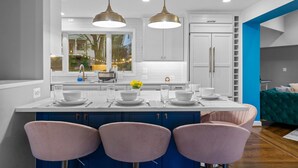 A modern kitchen with a central island, pendant lighting, and a view of the outdoors. - 6 Bed High End Home w/ EPIC Backyard! (Arlington)