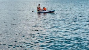 A person in a small boat on a calm body of water with mountains in the background. - Chez Marie Lake I Mountains I Fantastic view I Lucerne  (Beckenried)