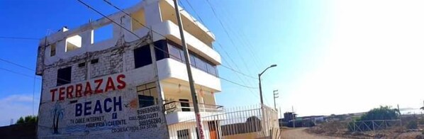 A multi-story building with the sign "TERRAZAS BEACH" indicating a beach resort.