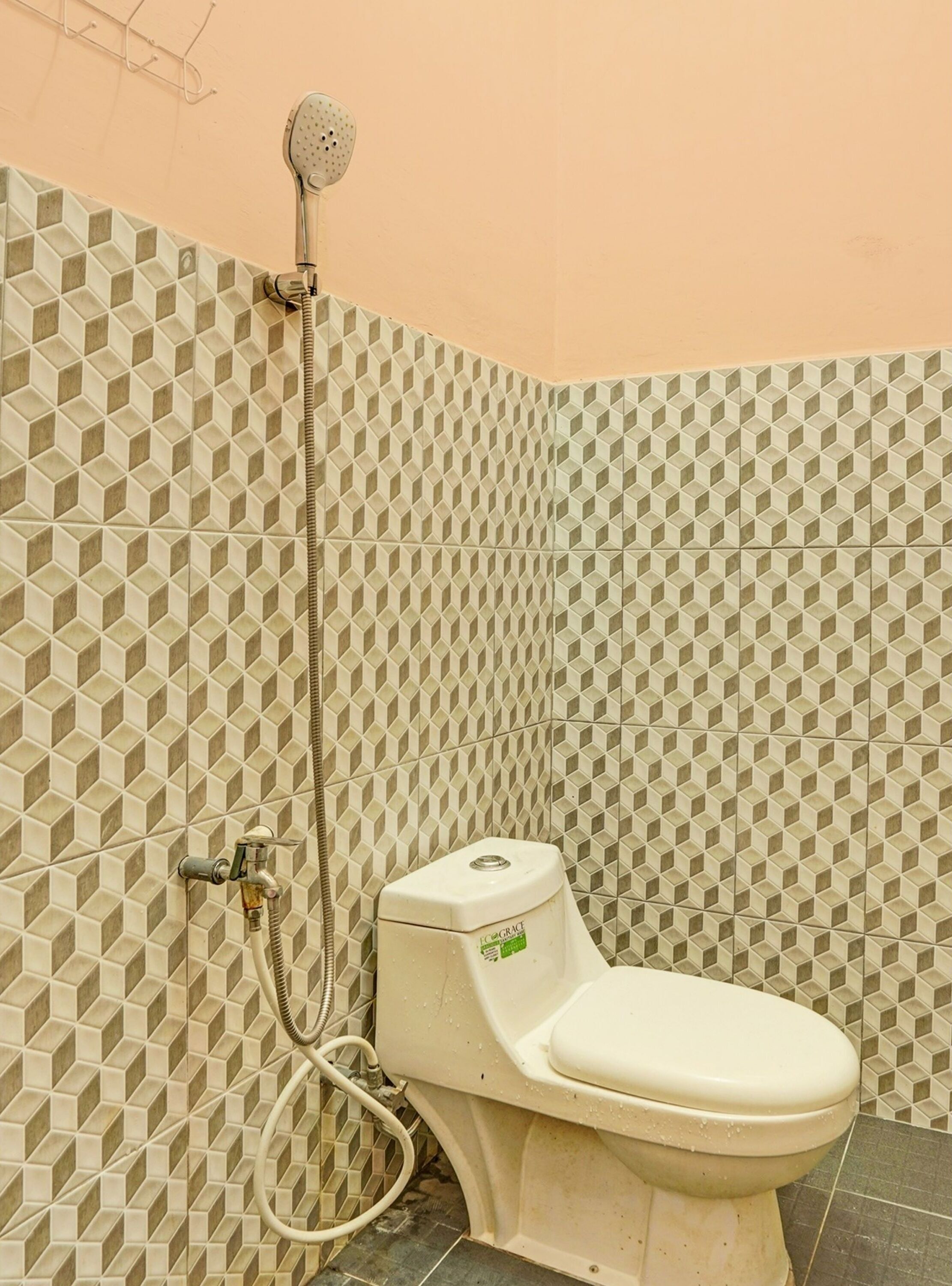 A bathroom with a toilet, shower, and tiled walls.