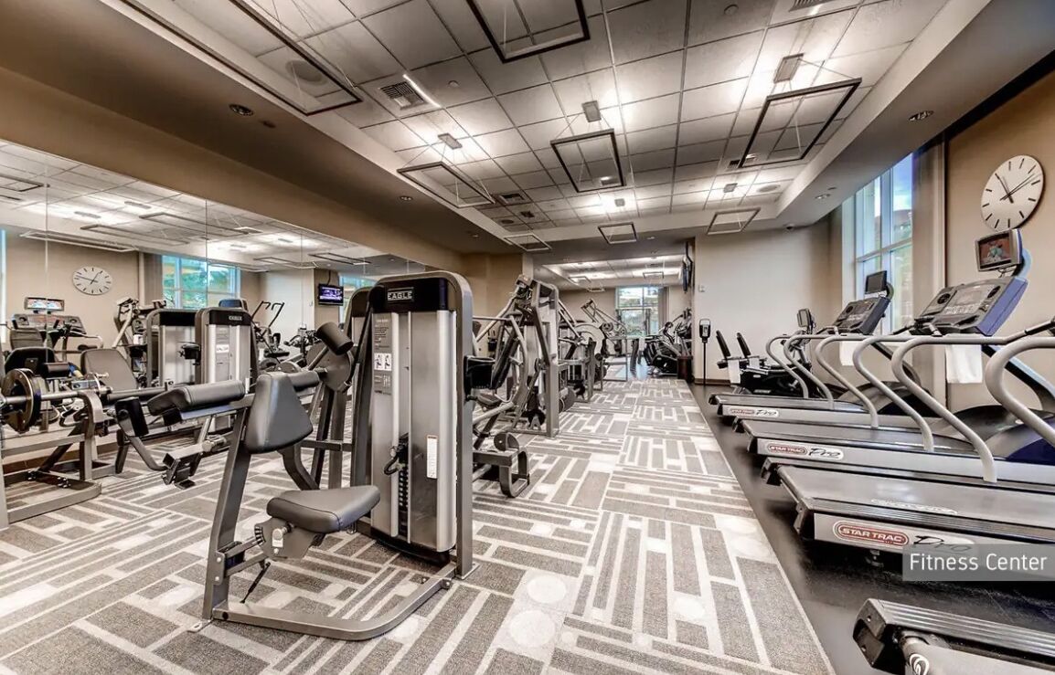 A fitness center with treadmills, weight machines, and exercise equipment.