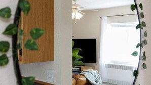 A room with a bed, a TV, and a window. - Sleeps 7{SPACIOUS}Pets Welcome! (Sheboygan)