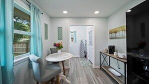 A compact kitchen with a dining area, a coffee machine, and a view of the outside. - Spacious 4/2BR Home |Pet-Friendly |Midtown Tulsa (Tulsa)