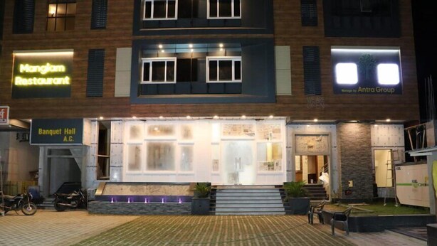 A building with a restaurant named 'Manglam Restaurant' and 'Banquet Hall A.C.' on the ground floor. - Hotel Manglam (Pachpadra)