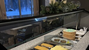 A buffet with various meats, cheeses, and a wooden bowl labeled 'brecc'. - Kårdal Fjellstove (Voss)