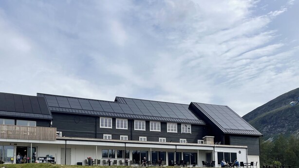 A modern building with a flat roof, large windows, and a covered outdoor seating area. - Kårdal Fjellstove (Voss)