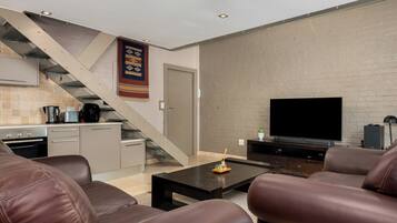 Exclusive Apartment | Living area | 50-inch flat-screen TV with cable channels, Netflix, streaming services