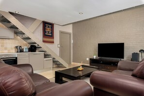 Exclusive Apartment | Living area | 50-inch flat-screen TV with cable channels, Netflix, streaming services