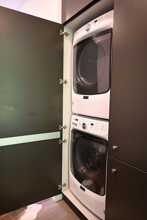 A laundry room with two stacked front-loading washing machines.