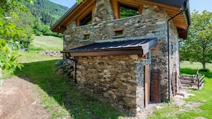 A stone cabin with a sloped roof, wooden beams, and a small window. - El Bait in Incudine With 2 Bedrooms and 1 Bathrooms (Incudine)