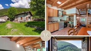 A rustic mountain cabin with a stone exterior, a wooden interior, a kitchen with modern appliances, a dining area, and a staircase leading to a loft bedroom with a view of the forest. - El Bait in Incudine With 2 Bedrooms and 1 Bathrooms (Incudine)